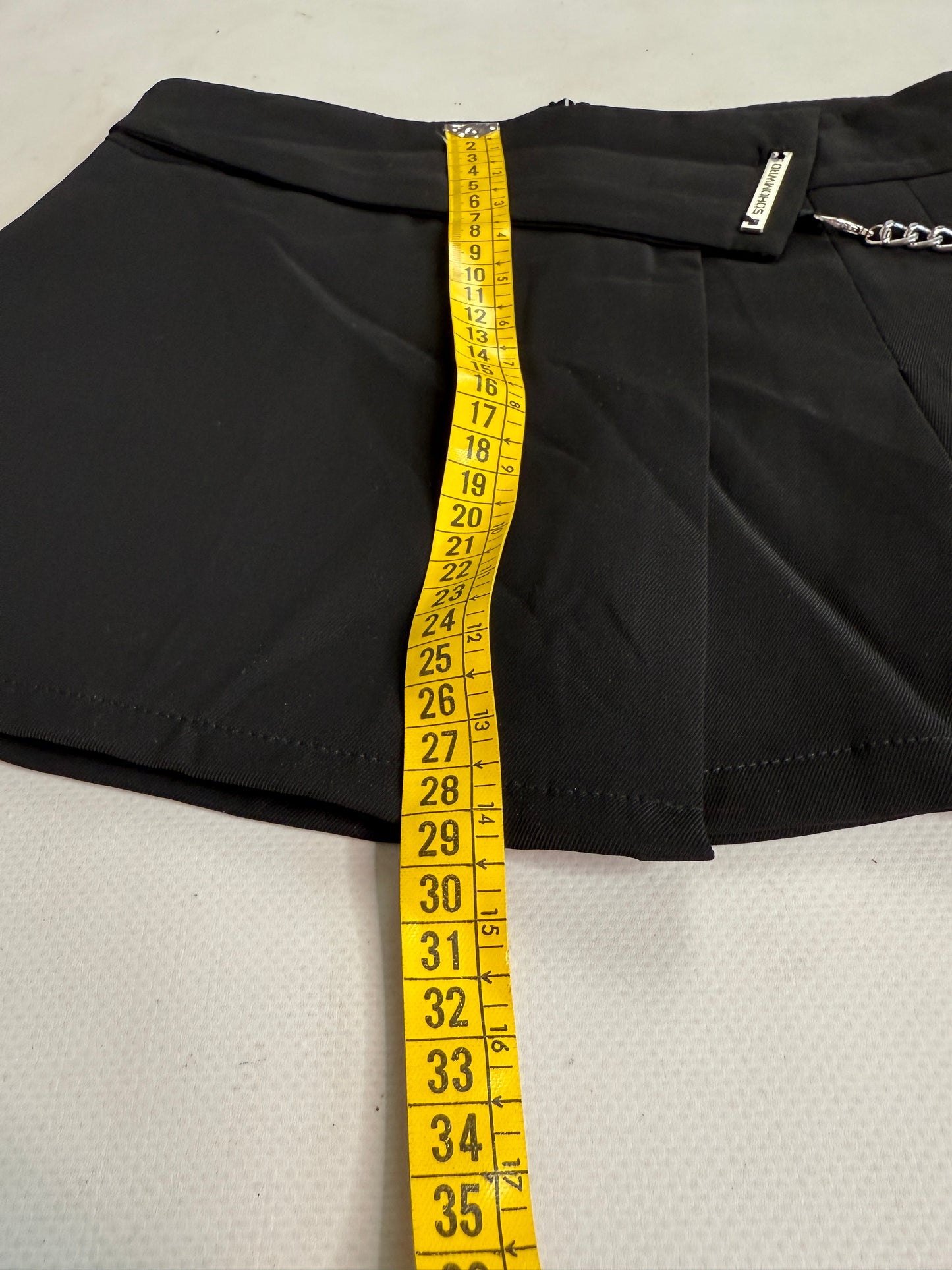 Black office siren mini skirt with chain details